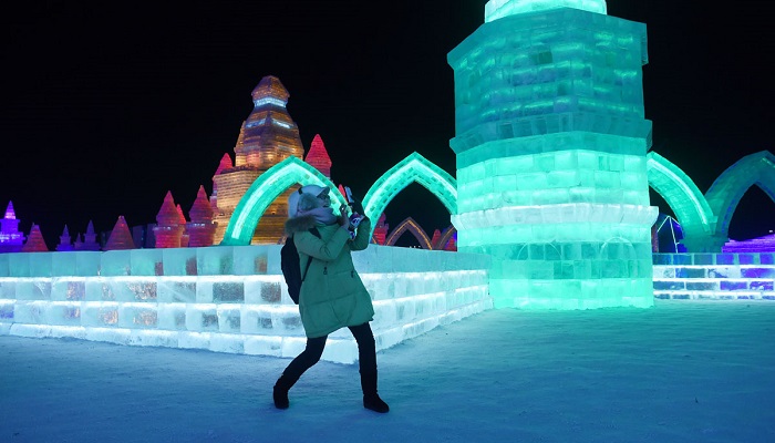 A woman uses a mobile phone to take a picture at the China Ice and Snow World on the eve of the opening ceremony of the Harbin International Ice and Snow Festival in Harbin, northeast China's Heilongjiang province on January 4, 2016. Over one million visitors are expected to attend the spectacular Harbin Ice Festival, where buildings of ice are bathed in ethereal lights and international ice sculptors compete for honours.     AFP PHOTO / WANG ZHAOWANG ZHAO/AFP/Getty Images