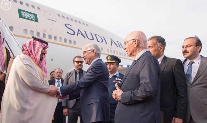 Saudi Arabia’s deputy crown prince and Defence Minister, Mohammed bin Salman shakes hands with Defence Minister Khawaja Asif after his arrival at Islamabad Airport on January 10, 2016. 