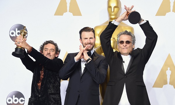 David White and Mark A Mangini, winners of the best sound editing award for Mad Max: Fury Road, with the actor Chris Evans (centre) Photo: Jason Merritt/Getty Images