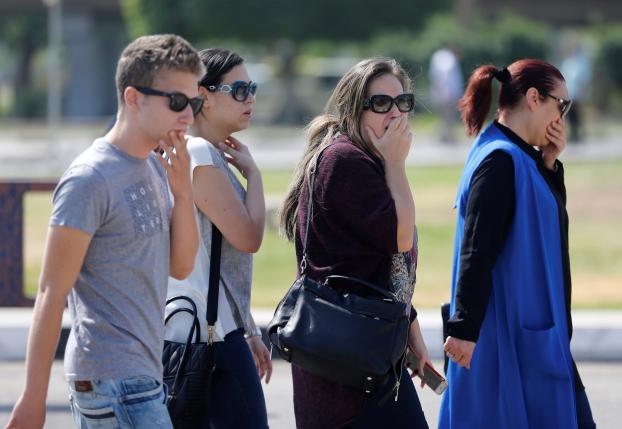 Unidentified relatives and friends of passengers who were flying in an EgyptAir plane that vanished from radar en route from Paris to Cairo react as they wait outside Cairo International Airport, Egypt. Photo: REUTERS/AMR ABDALLAH DALSH