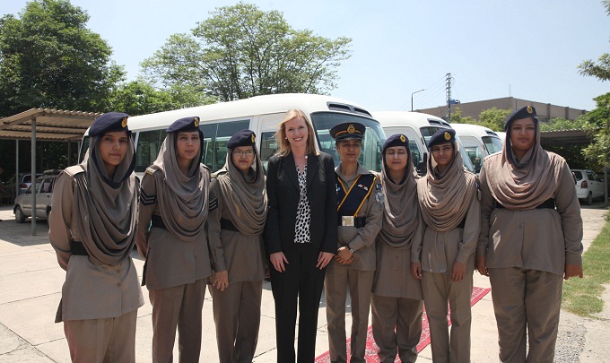 INL Director Katie Stana presents five mini buses to the Pakistan NH&MP Inspector General to provide transportation for women police officers