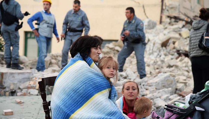 Victims sit among the rubble of a house after a strong earthquake hit Amatrice on August 24, 2016. Photo: Getty Images