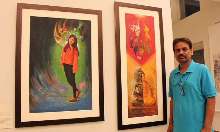 Pakistani artist Zahid ul Haq standing alongside his paintings at joint exhibition by Pakistani and Chinese artists at PNCA in Islamabad on 18 Oct. 2016. Photo: Sana Jamal