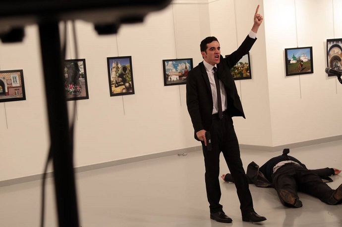 An unnamed gunman gestures after shooting the Russian ambassador to Turkey, Andrei Karlov, at a photo gallery in Ankara, Turkey on Monday. Photo: Burhan Ozbilici/Associated Press